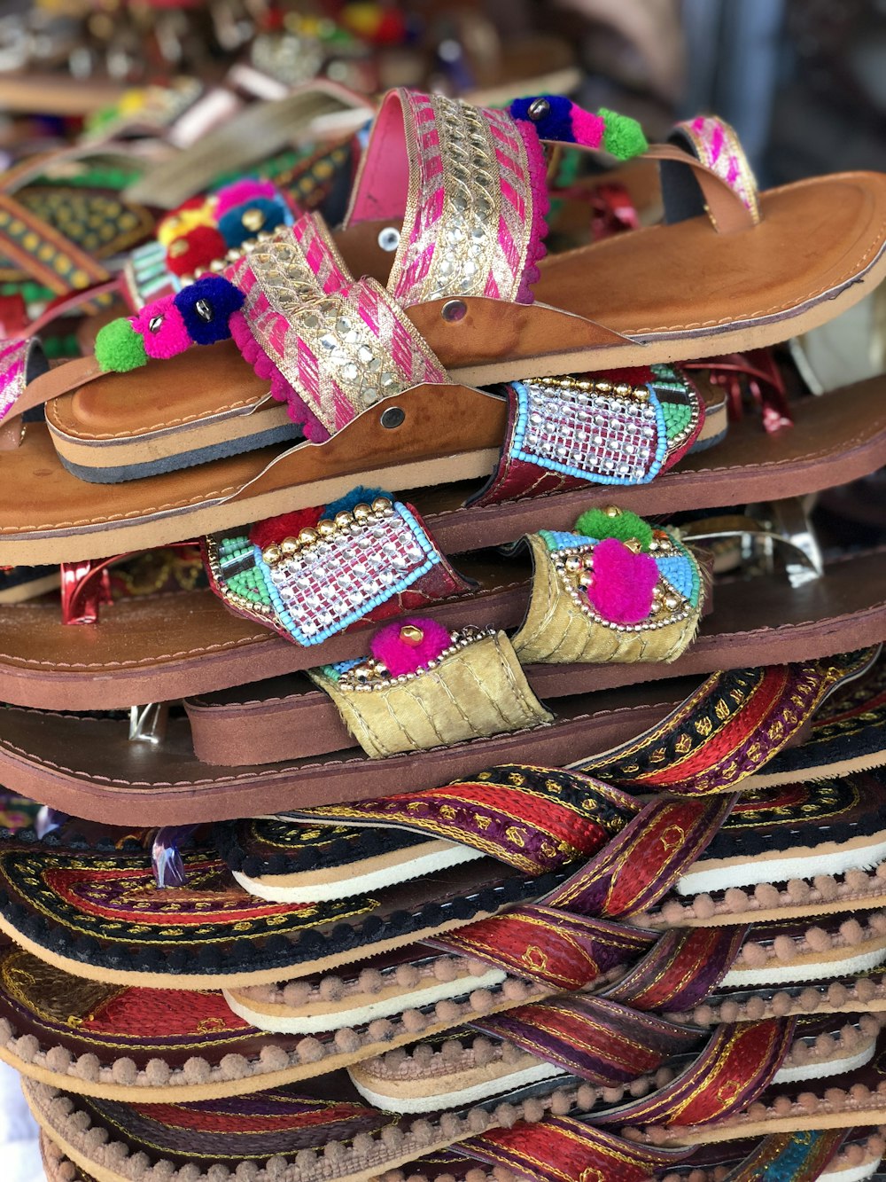 a pile of colorful sandals and sandals on display