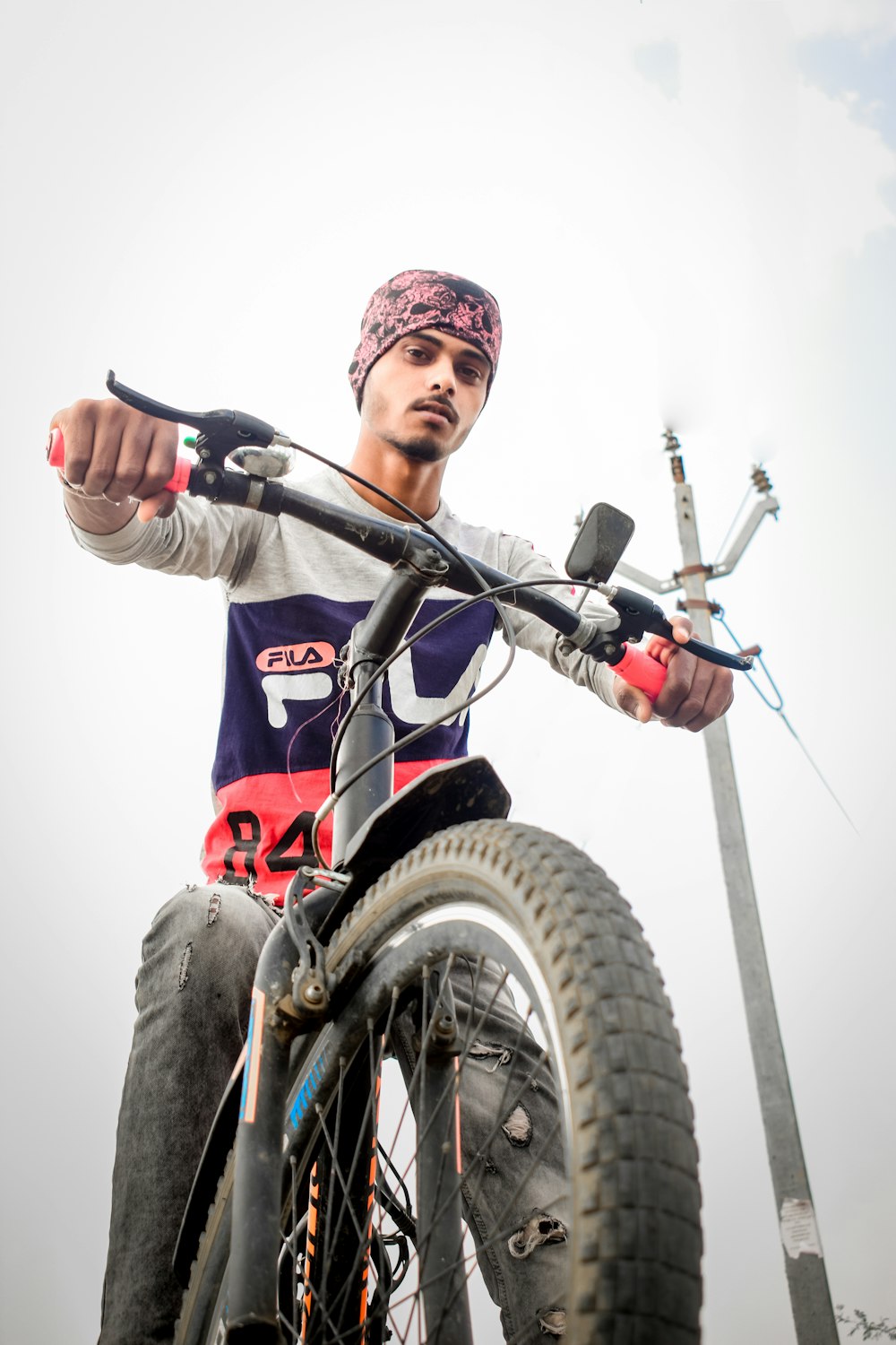 a man riding a bike on top of a dirt field