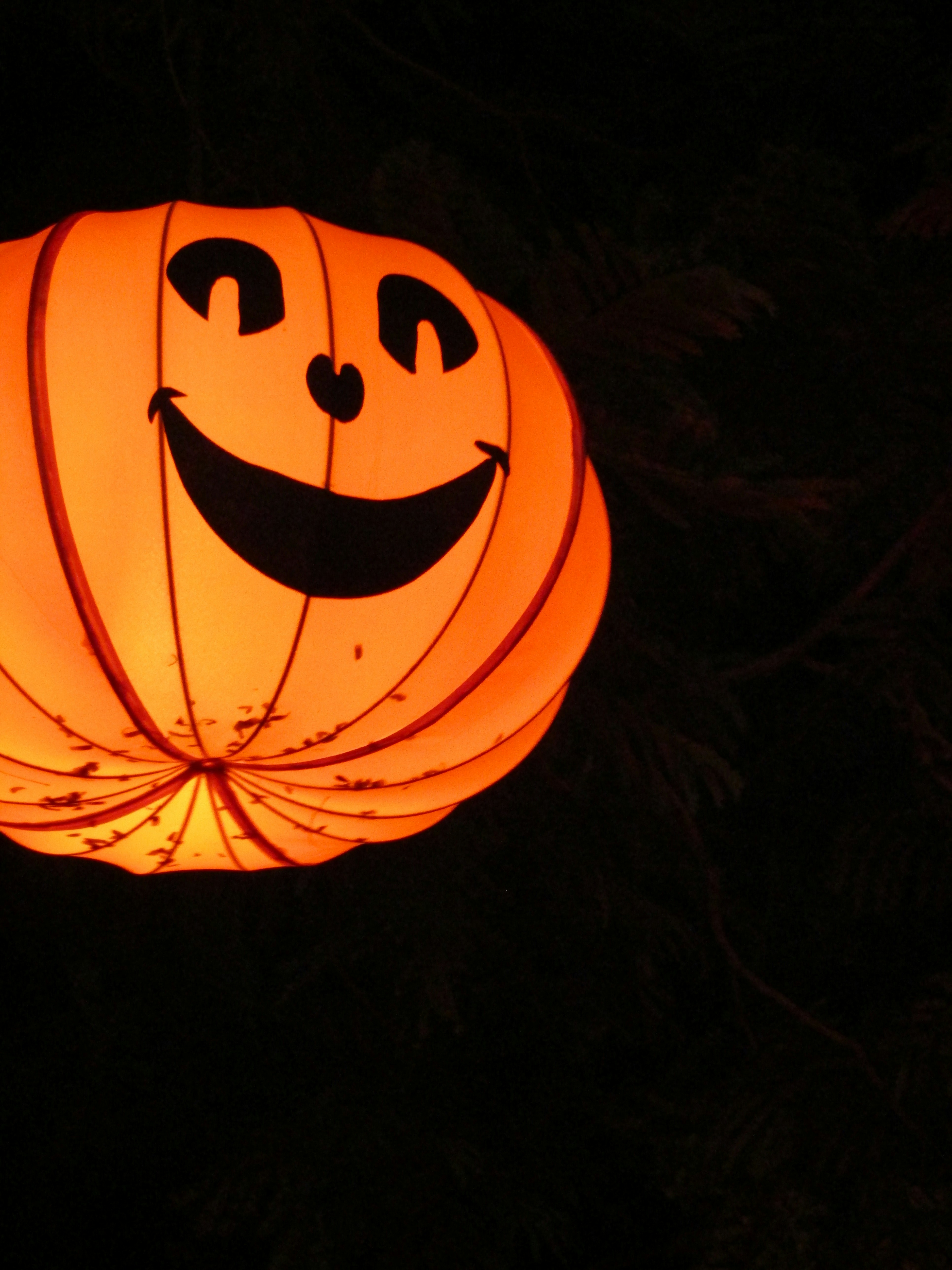 a lantern with a face on it in the dark