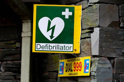 a green and yellow sign with a heart on it