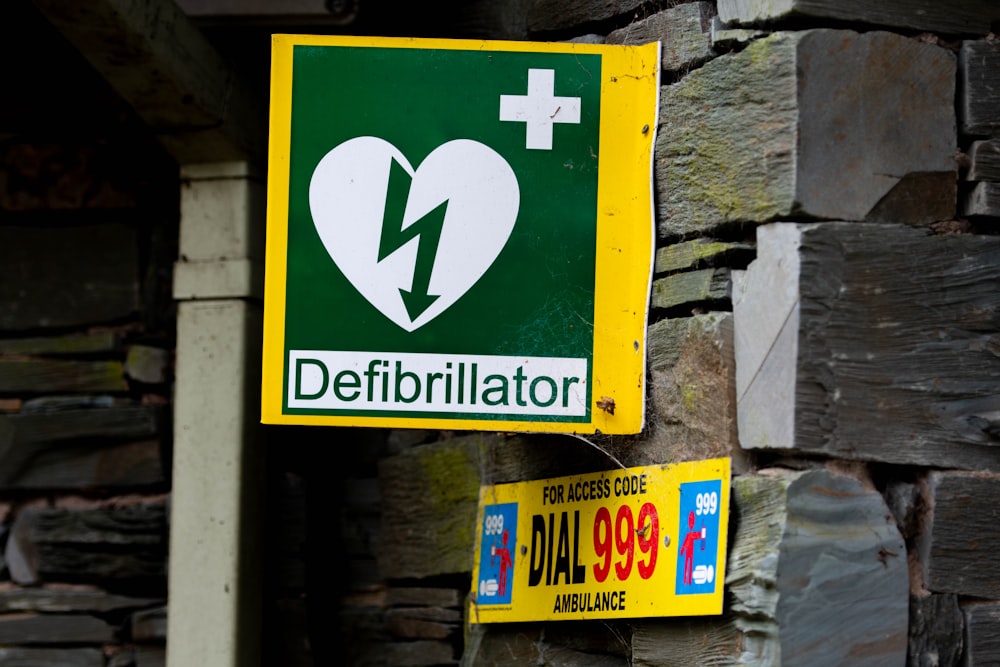 a green and yellow sign with a heart on it