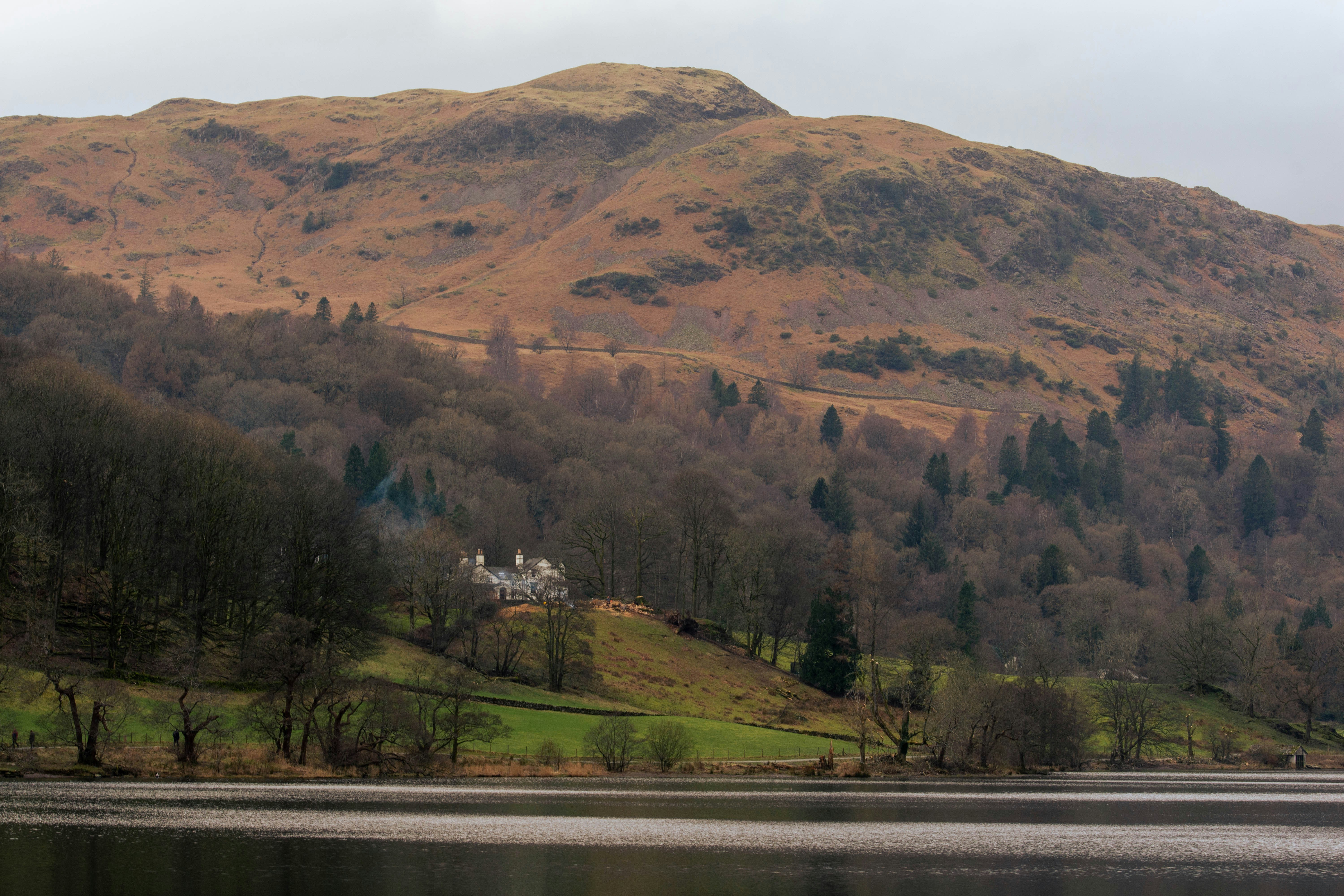 a house on a hill overlooking a lake