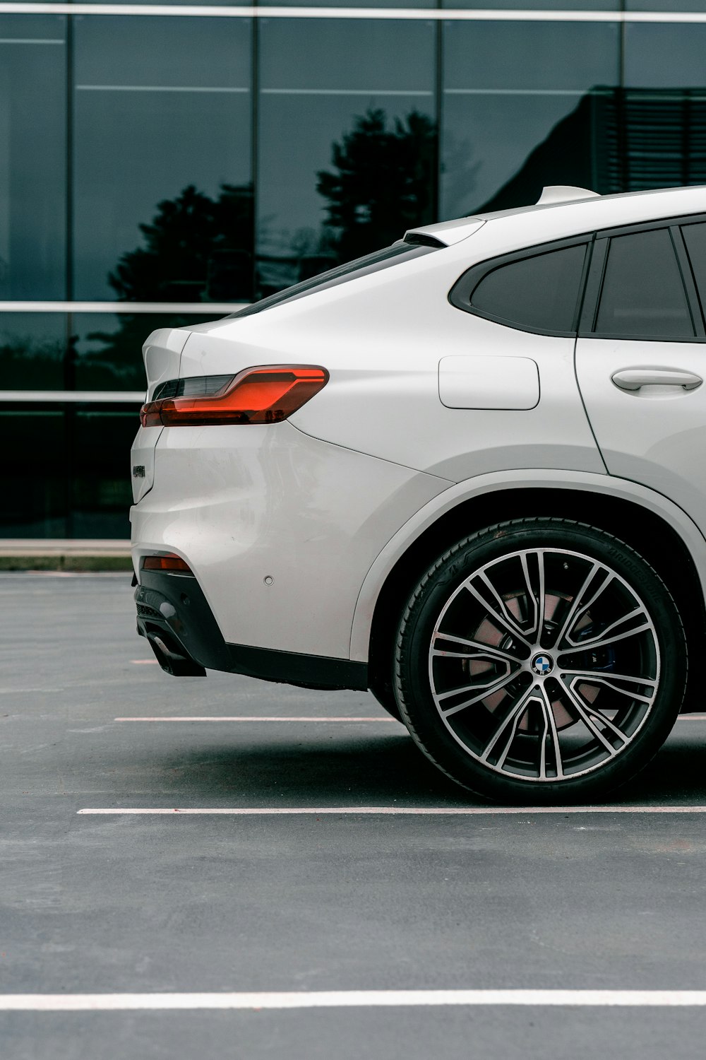 a white bmw suv parked in a parking lot