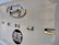 Close-up of a car trunk with a shiny silver Hyundai emblem and the word 'VENUE' in chrome letters. Below these, a black oval sticker features a white Shiva linga with a flame design and Devanagari script.