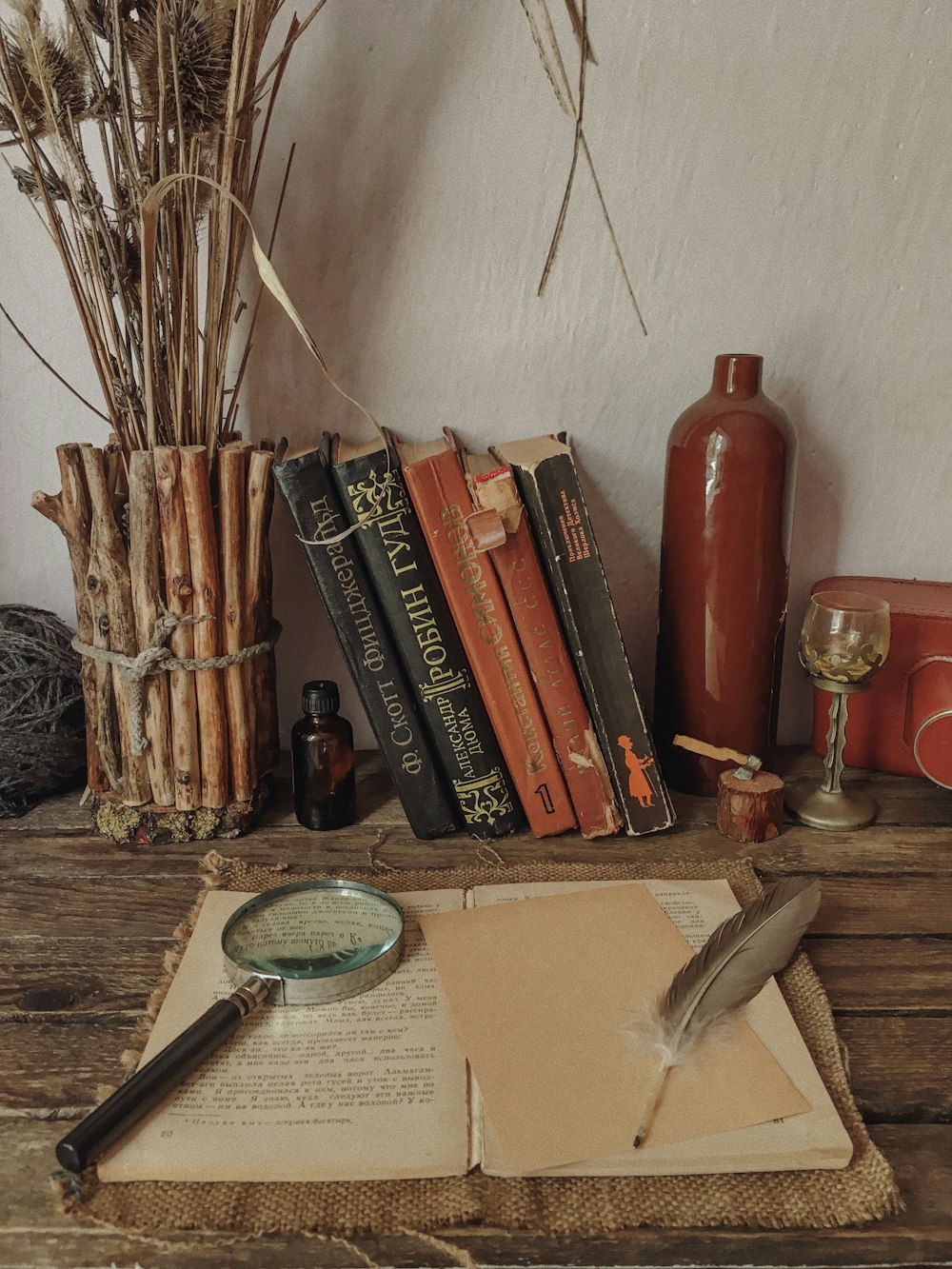 a table topped with books and a magnifying glass