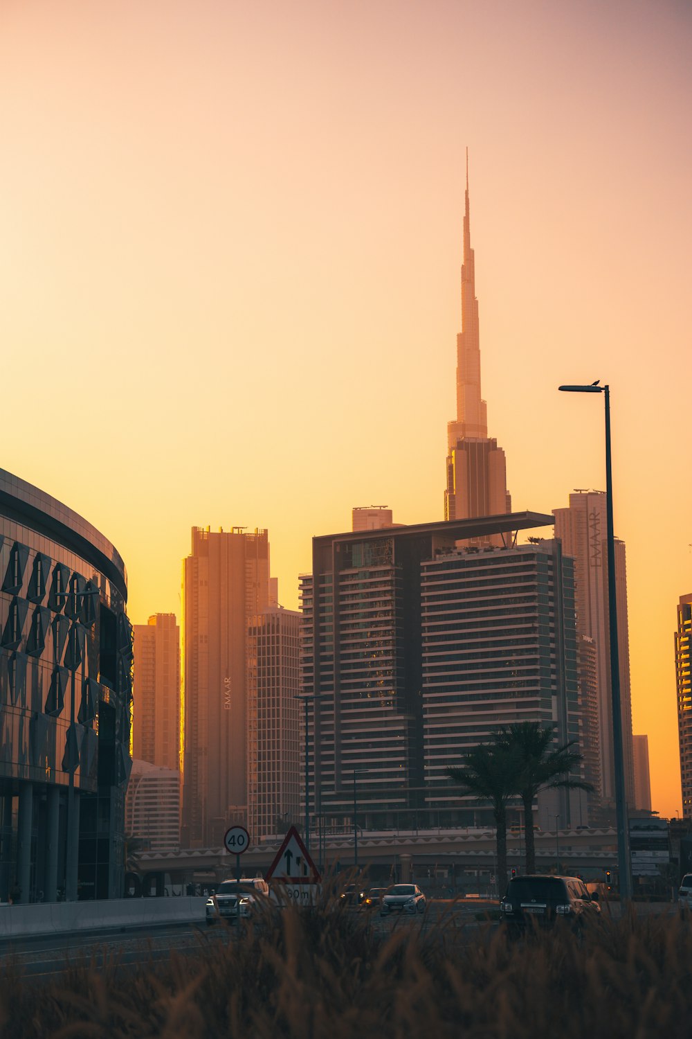 a view of a city with tall buildings at sunset