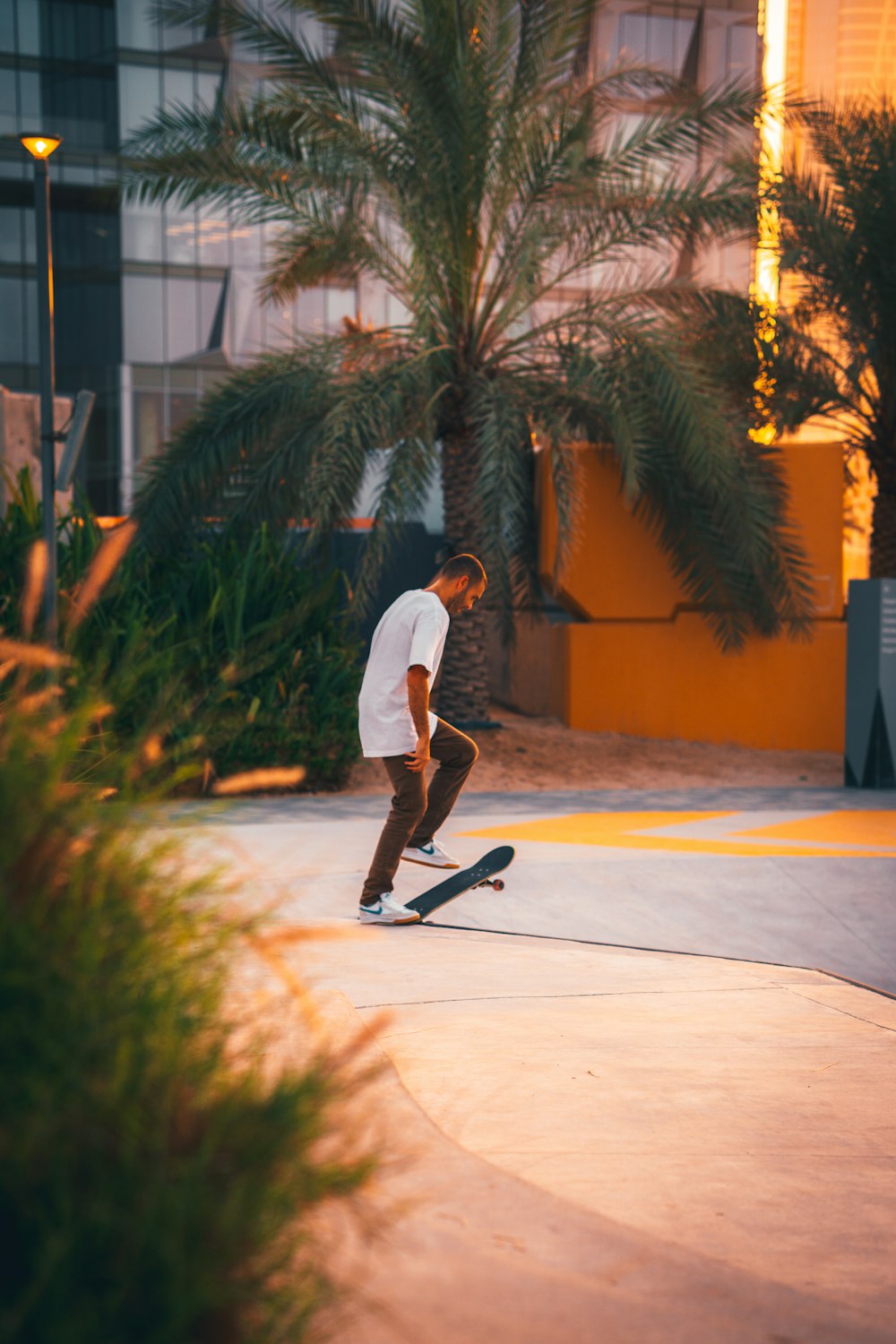 a man riding a skateboard down a sidewalk