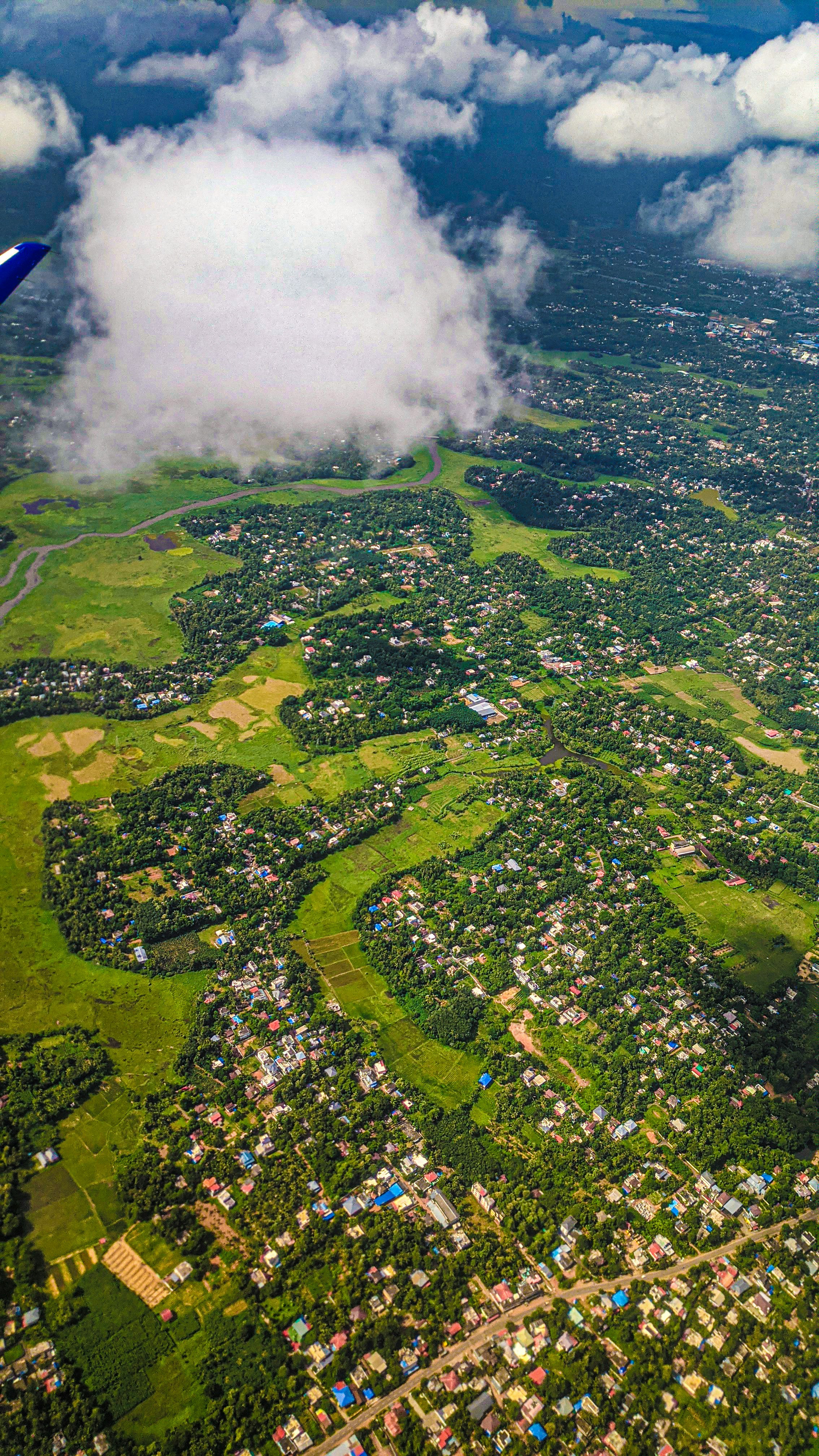 An aerial view of a small town surrounded by clouds photo – Free Sky ...