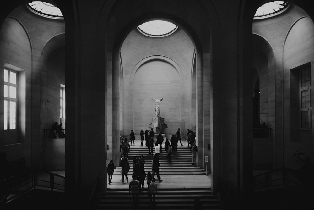 a black and white photo of people in a church