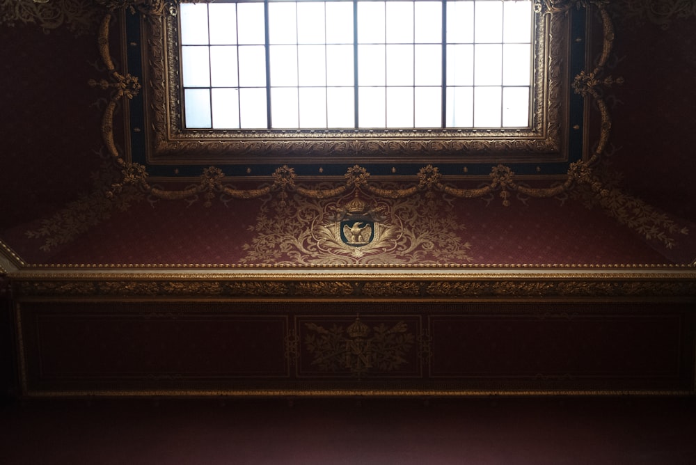 a window in a room with a red wall