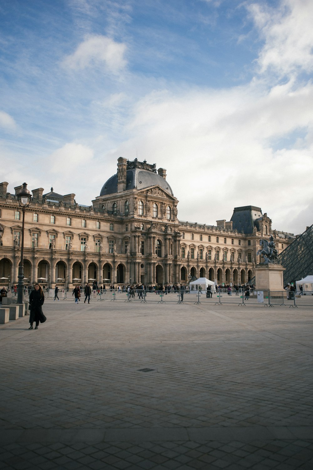 a large building with a lot of people walking around it