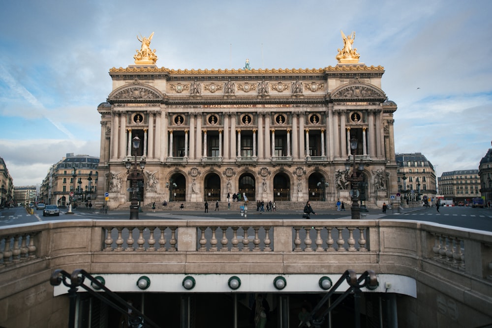 a large building with gold statues on top of it