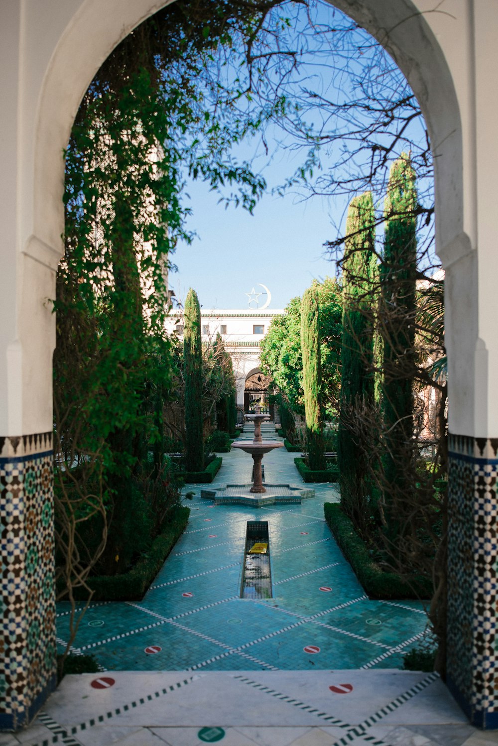 a view of a fountain through an archway