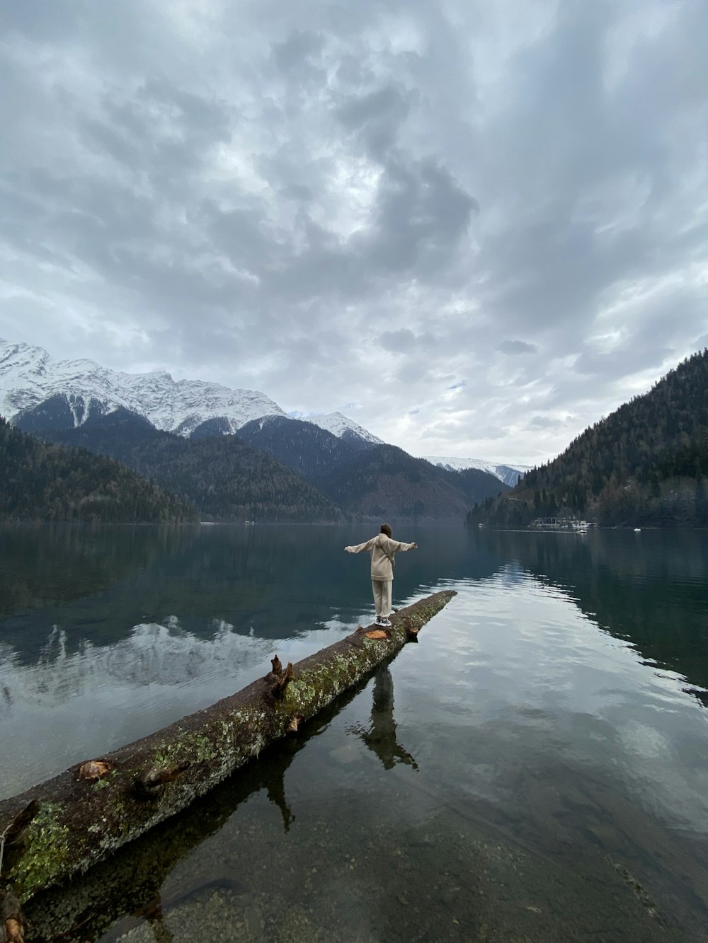 a man standing on a log in the water