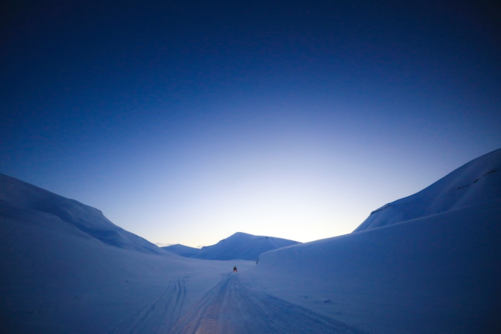 a person riding skis down a snow covered slope