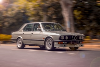 A powerful sedan cruising on a winding road post-subiremapping, captured in motion