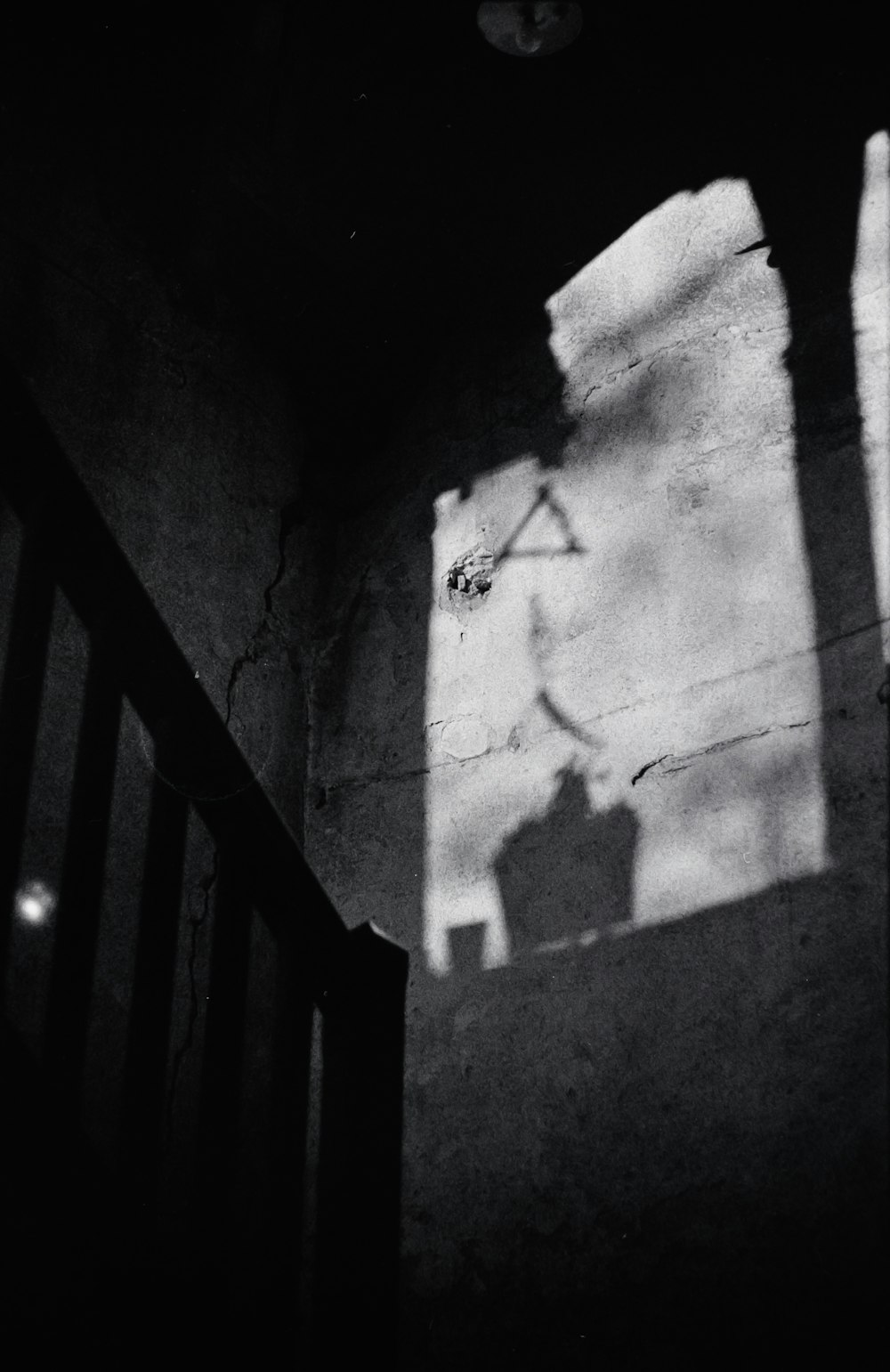 a shadow of a clock on a wall