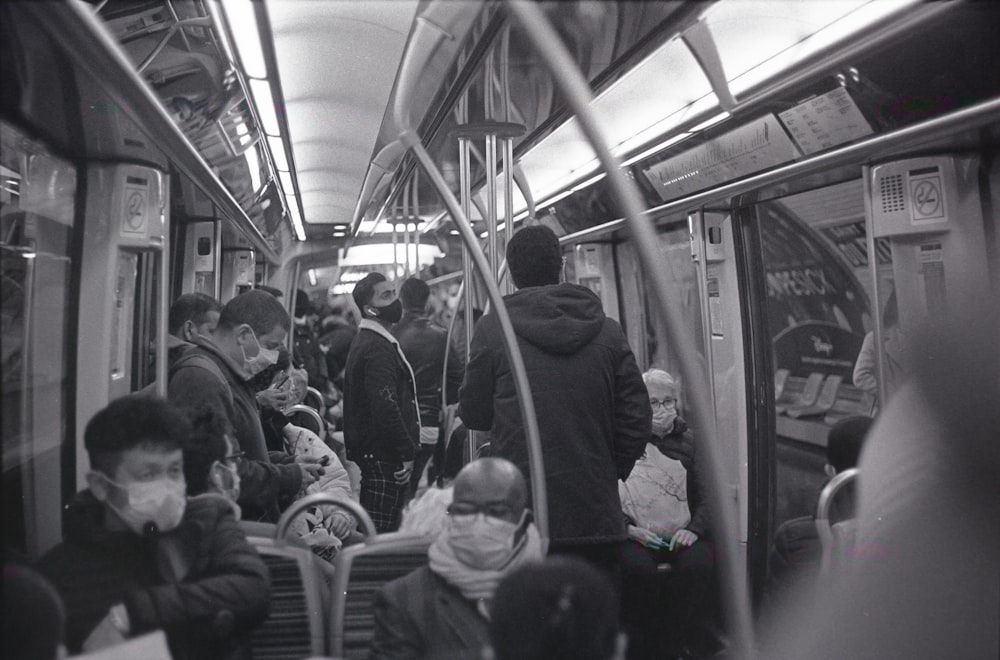 a group of people riding on a subway train