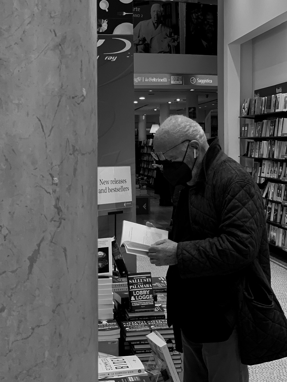 a man reading a book in a bookstore
