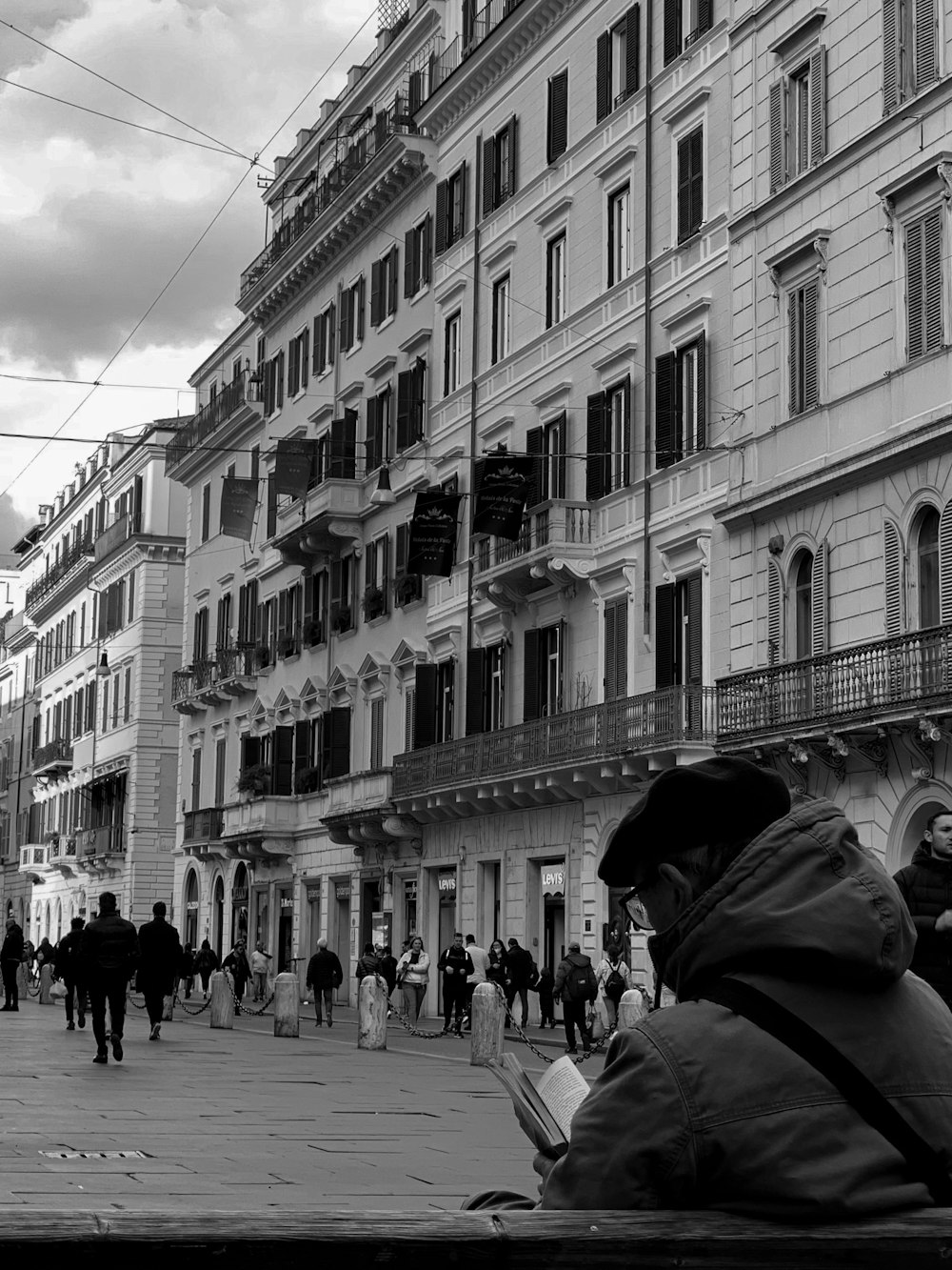 a man sitting on a bench in front of a building