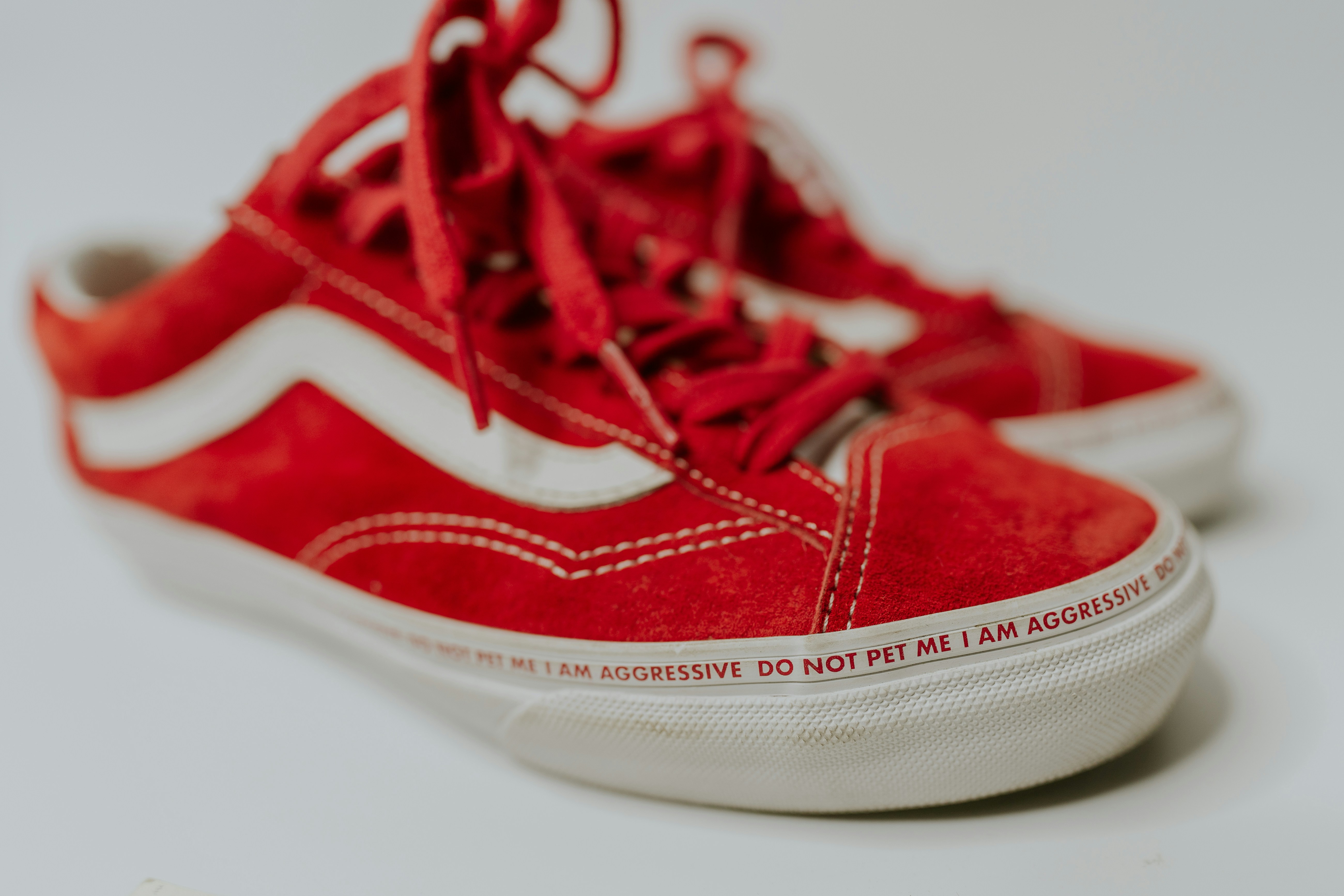 a pair of red sneakers with white laces