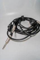 Various car audio cables and plug-and-play connectors neatly arranged on a white surface with light green highlights.