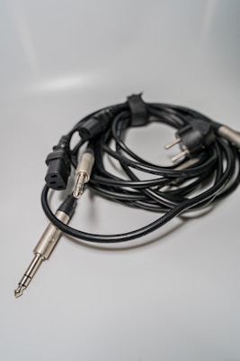 Brightly lit audio cables with gold-plated connectors arranged in a fan shape.