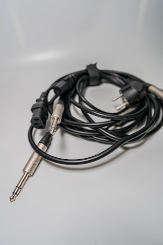 A close-up of various audio cables and connectors neatly arranged on a table.