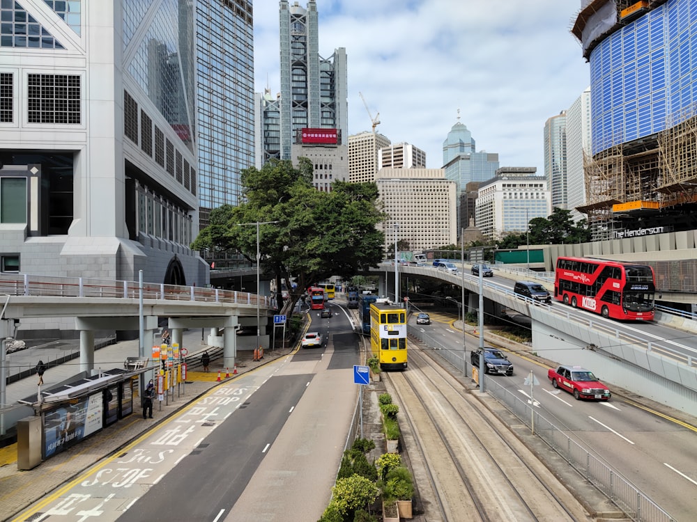 a city street filled with traffic next to tall buildings