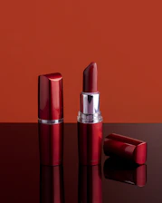 a red lipstick sitting on top of a table