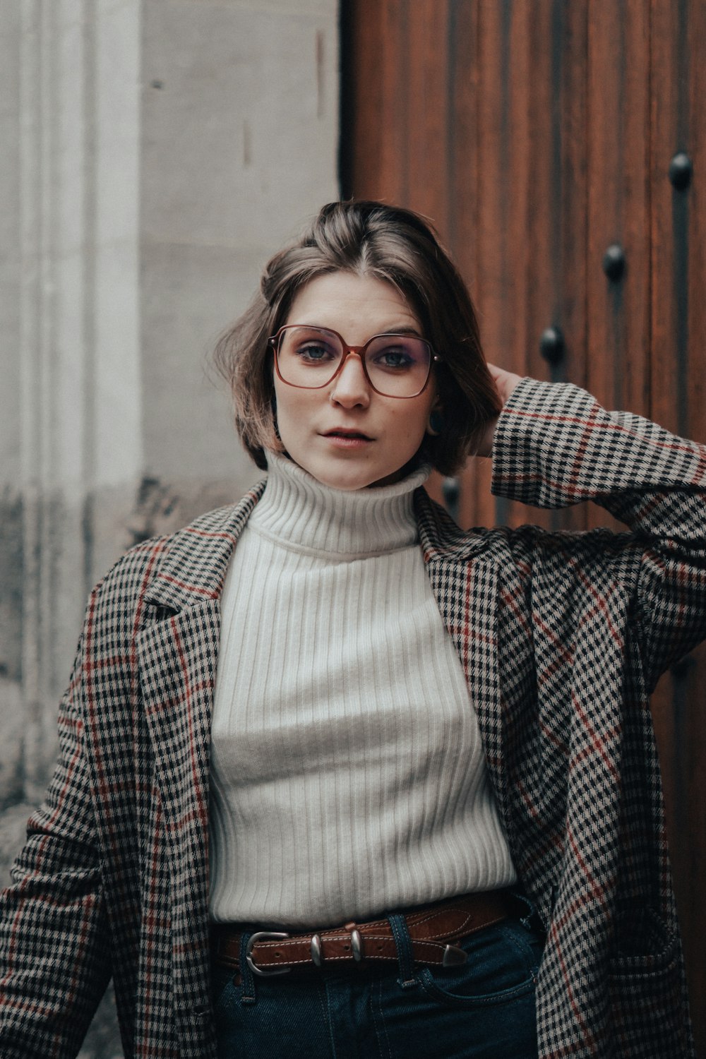 a person wearing glasses and smiling at the camera