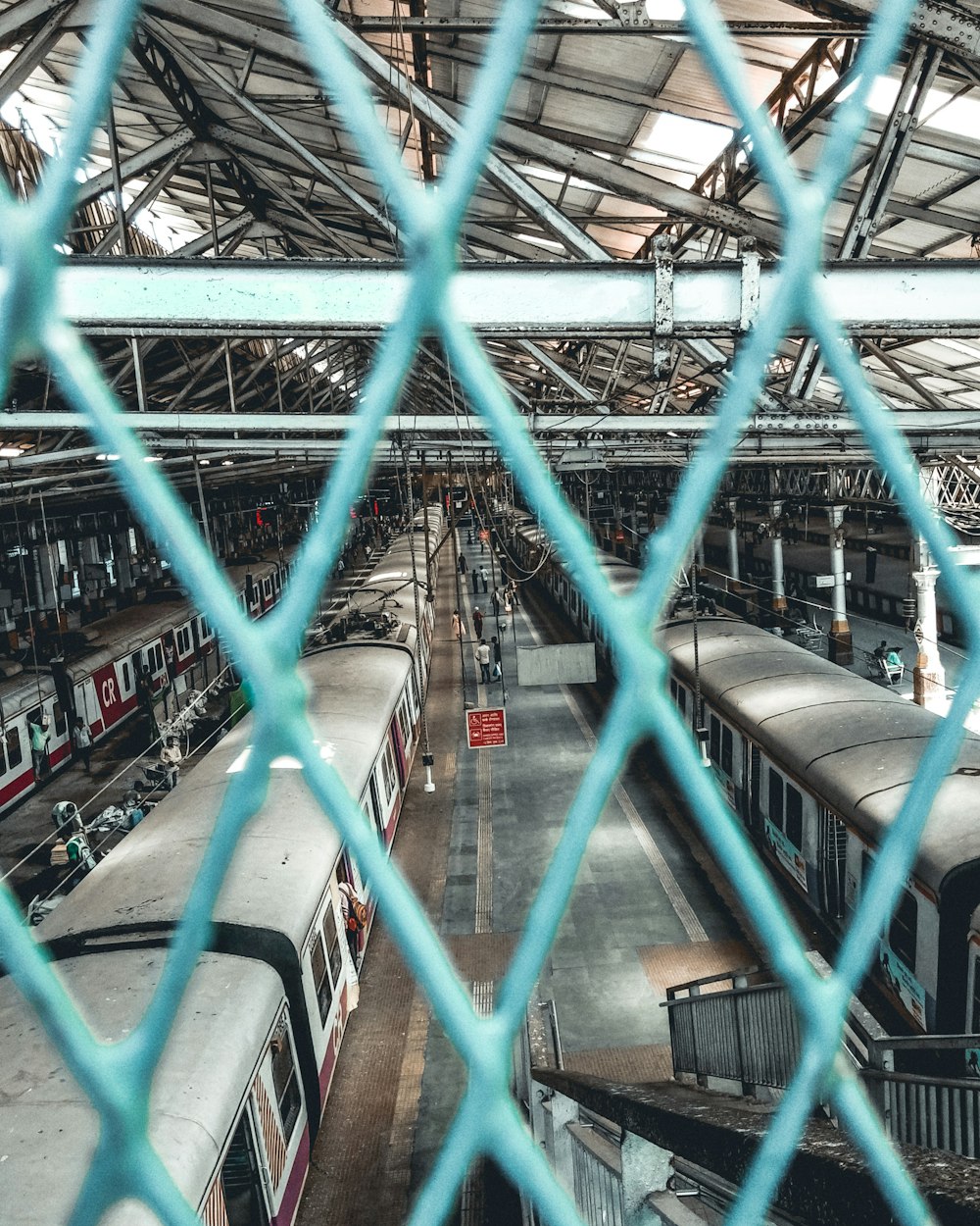 a view of a train station through a chain link fence