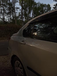a white car parked on the side of a road
