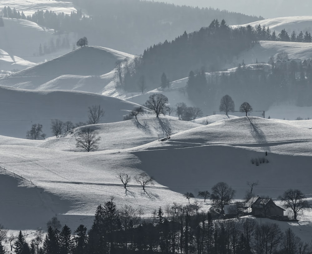 a black and white photo of snow covered hills