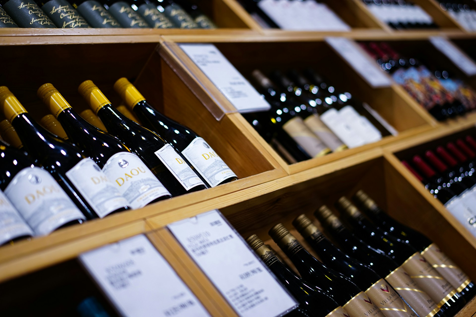 a bunch of wine bottles that are on a shelf