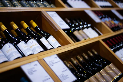 a bunch of wine bottles that are on a shelf