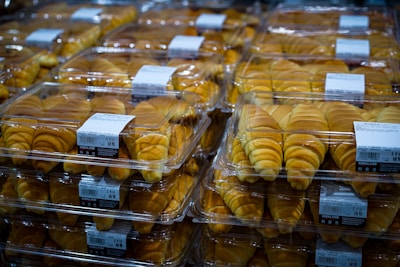 Boxes of freshly packed brioches ready for export stacked in a warehouse.
