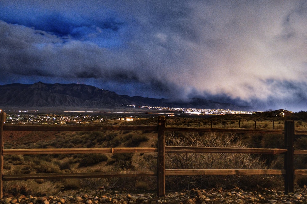 a fence with a view of a city in the distance