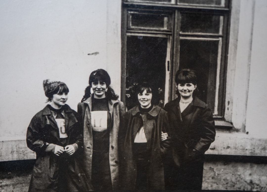 a group of women standing next to each other,