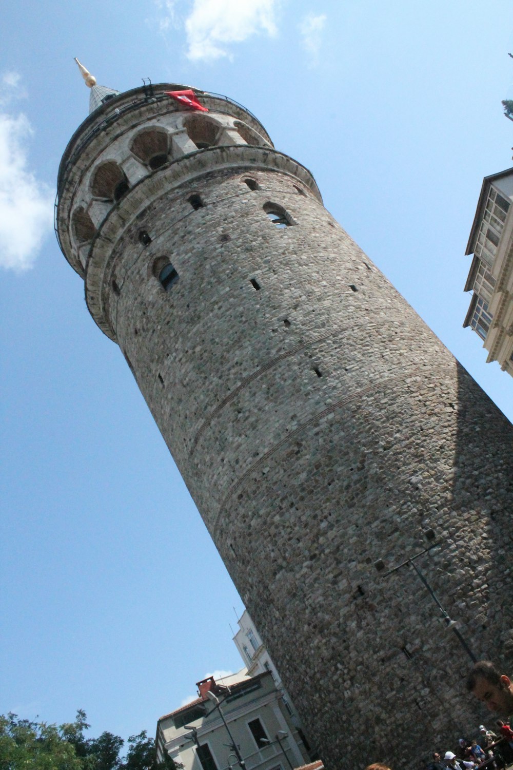 a tall tower with a flag on top of it