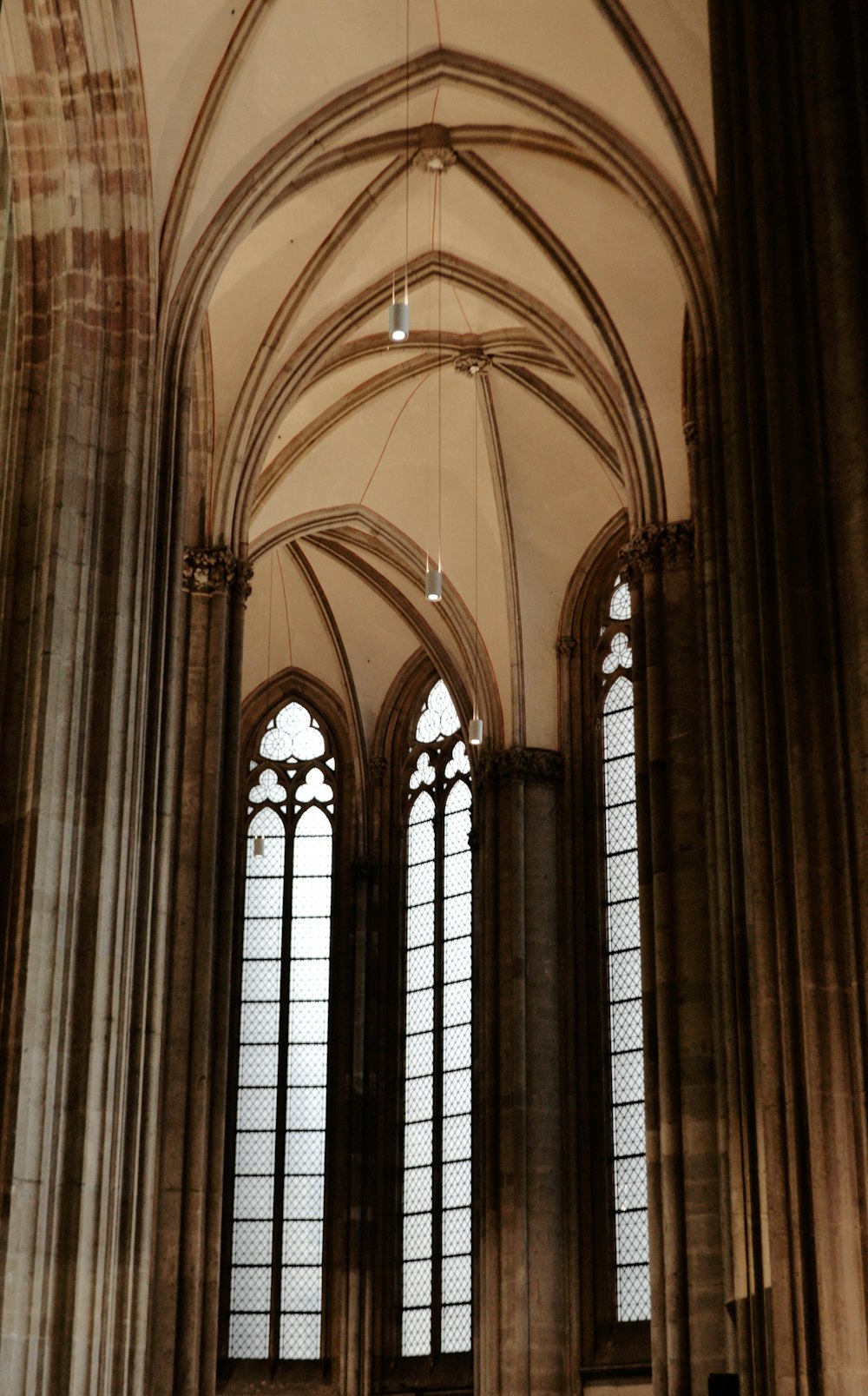 a large cathedral with a clock hanging from the ceiling