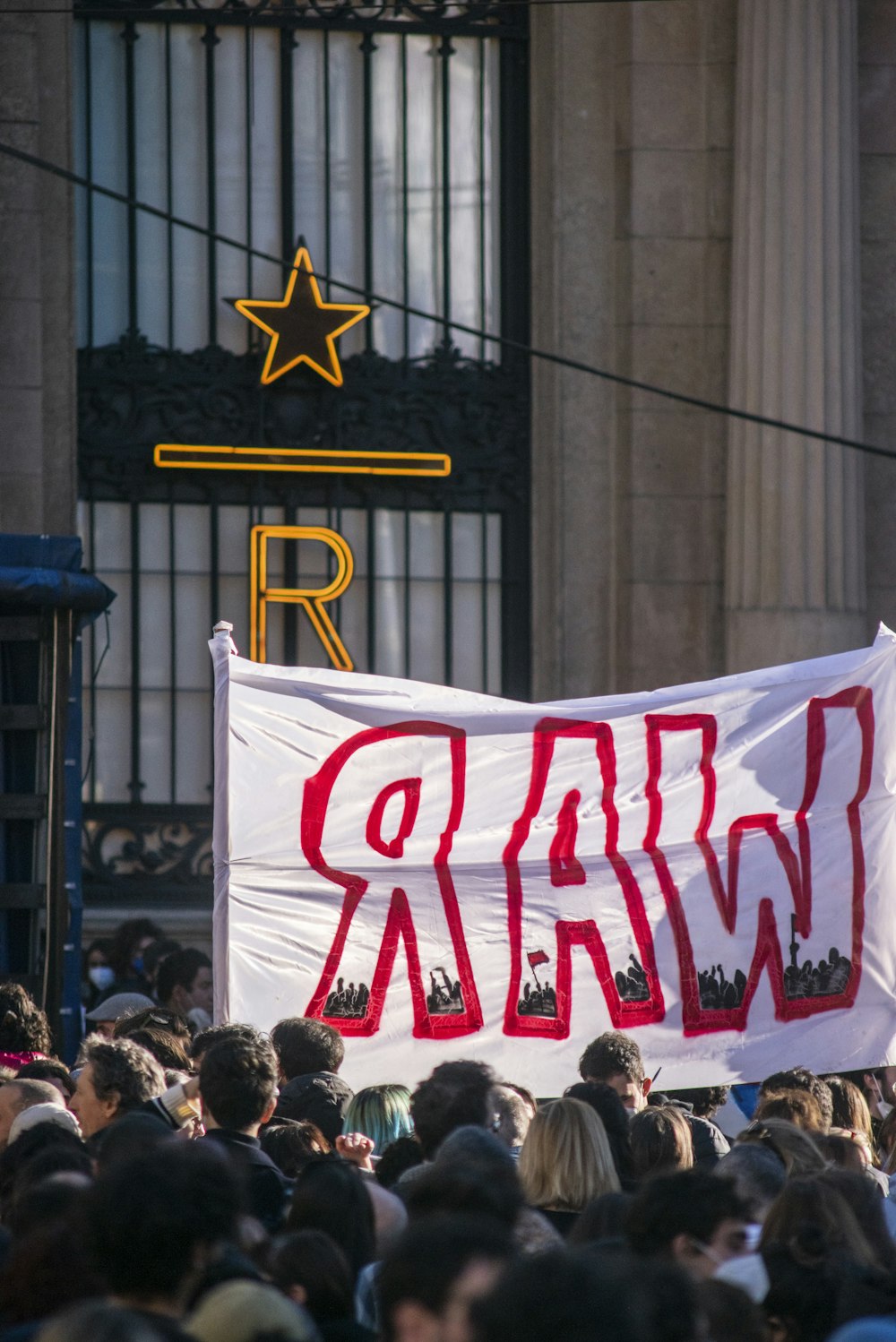 a crowd of people standing around a large sign