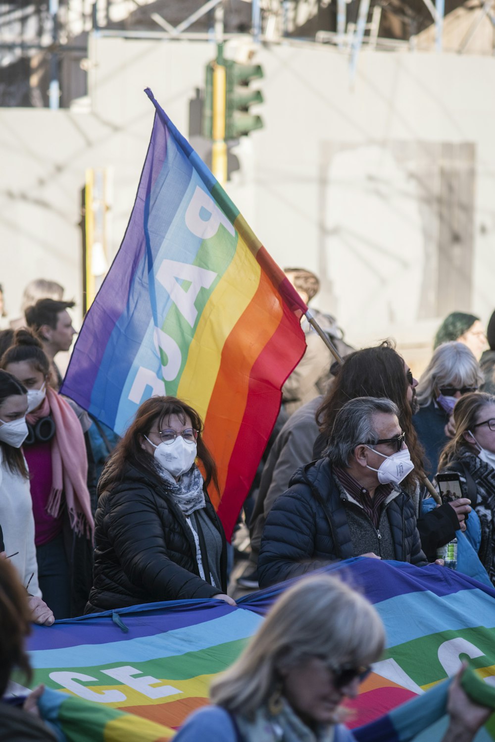 a group of people holding a rainbow flag