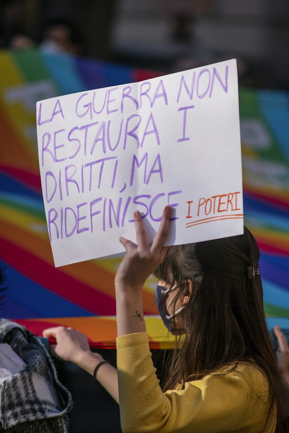 a woman holding up a sign with writing on it