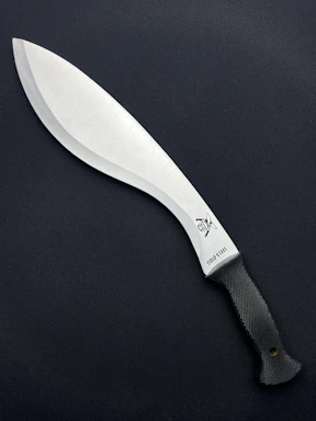 a large knife with a black handle on a black surface