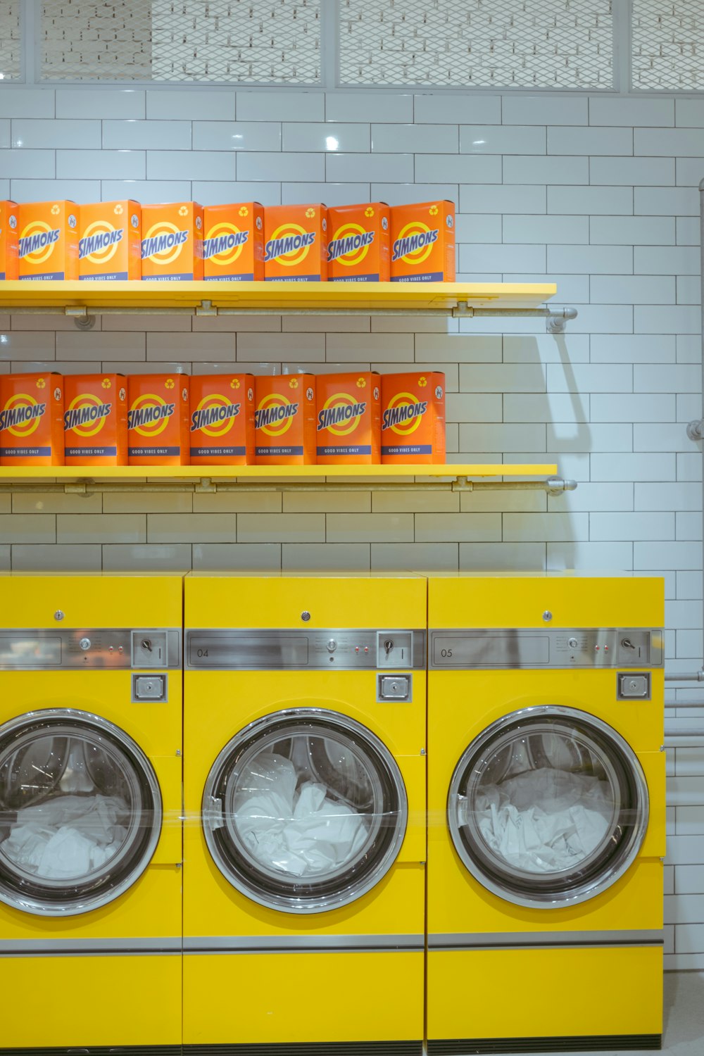 a yellow washer and dryer in a room