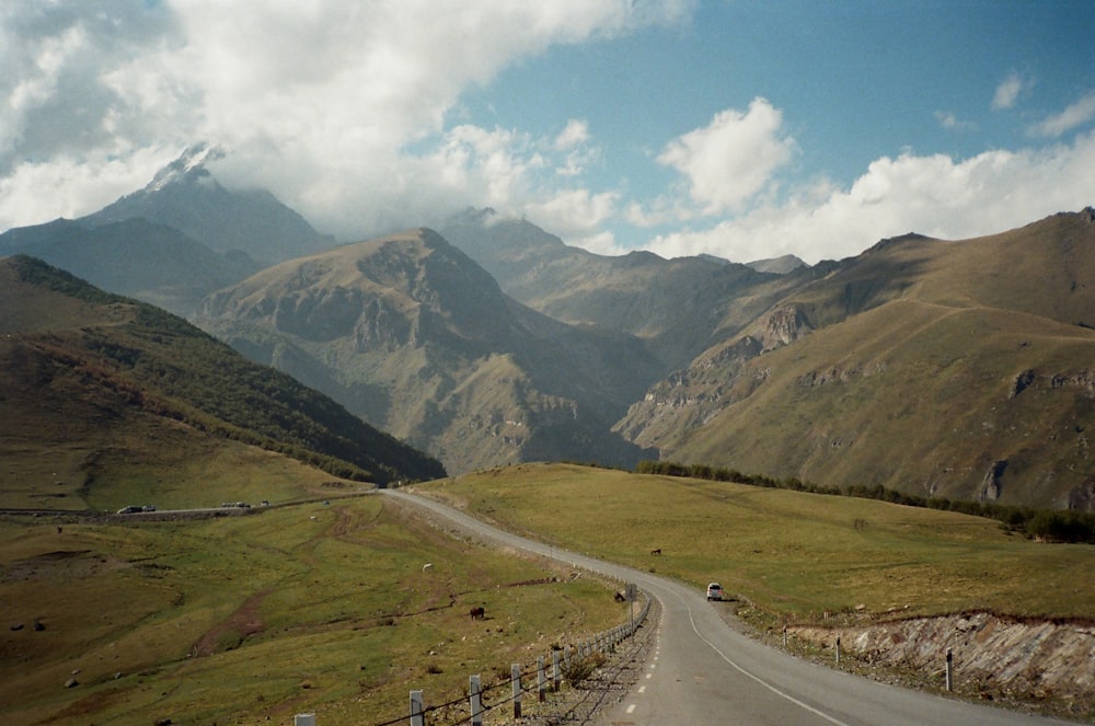 a scenic view of mountains and a road