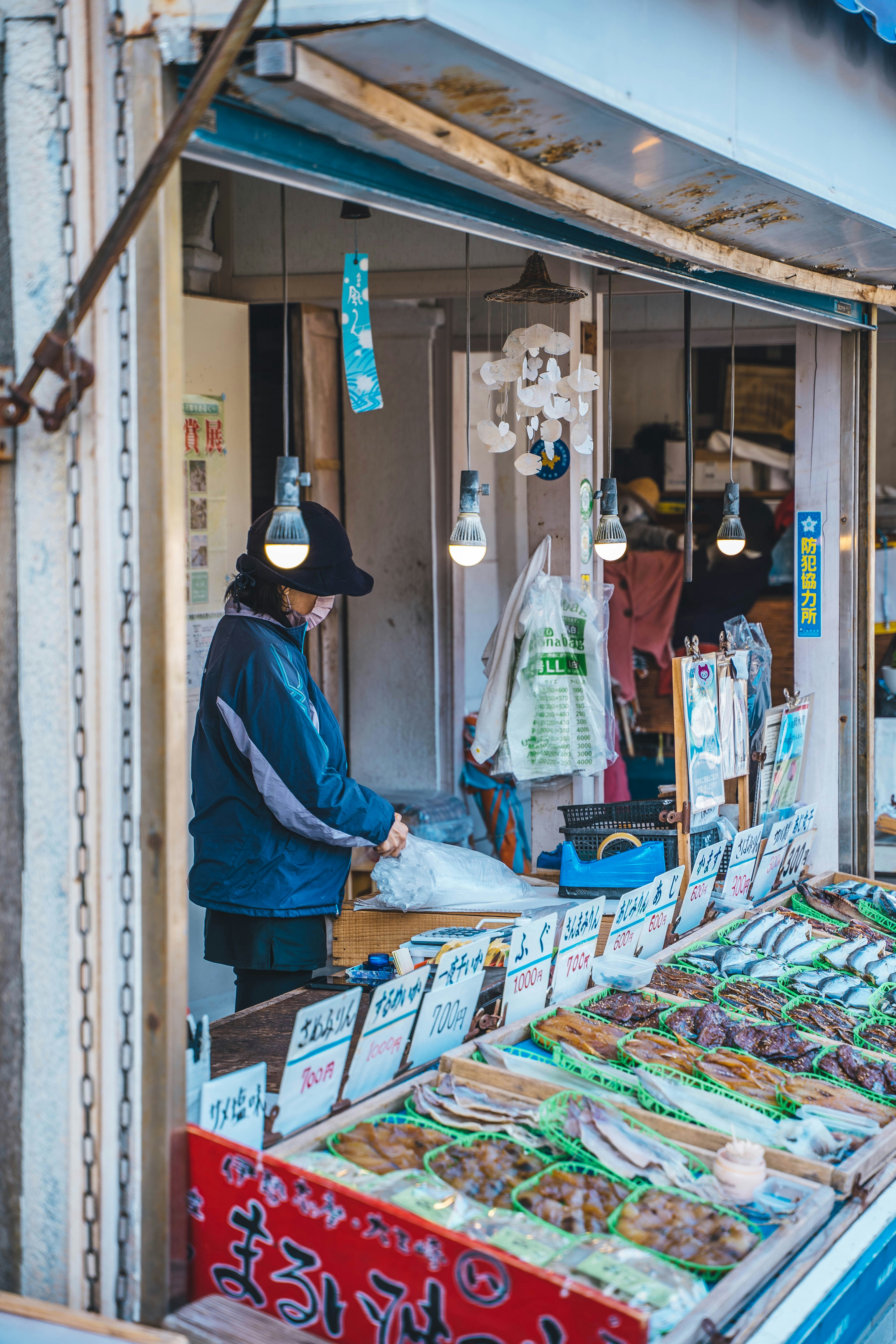 a man standing in front of a food stand