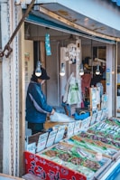 a man standing in front of a food stand