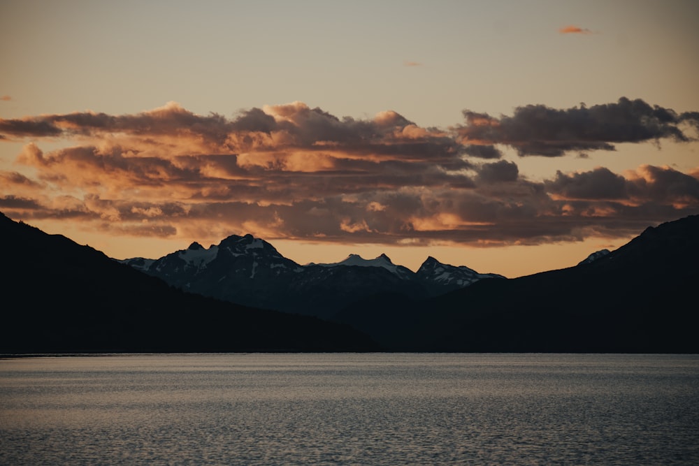 a large body of water with mountains in the background